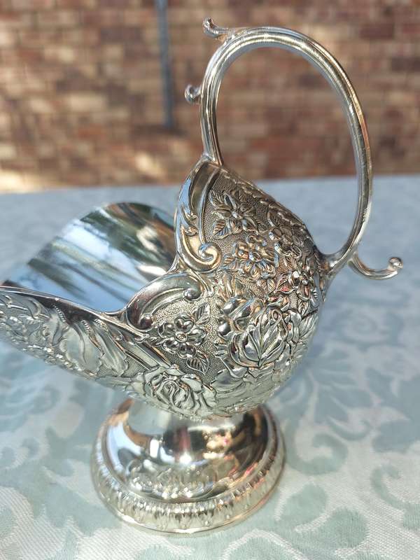 A VINTAGE SILVERPLATED SUGAR SCUTTLE SOLD AS IS