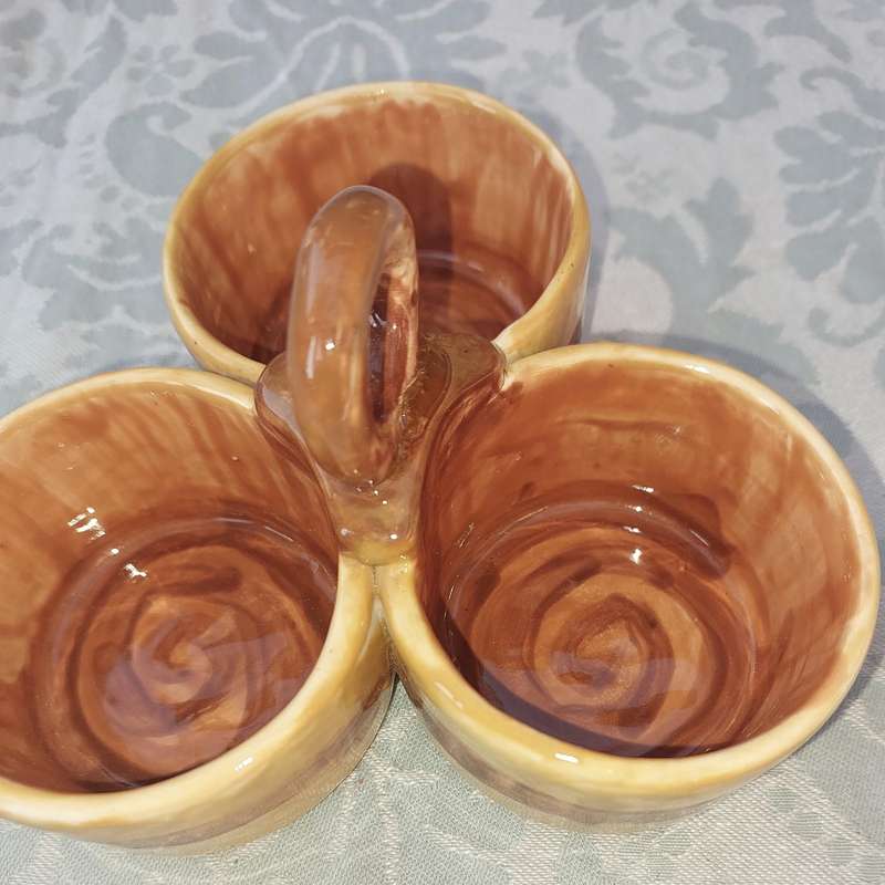 A HANDMADE CERAMIC THREE-COMPARTMENTED CONDIMENT CADDY SOLD AS IS