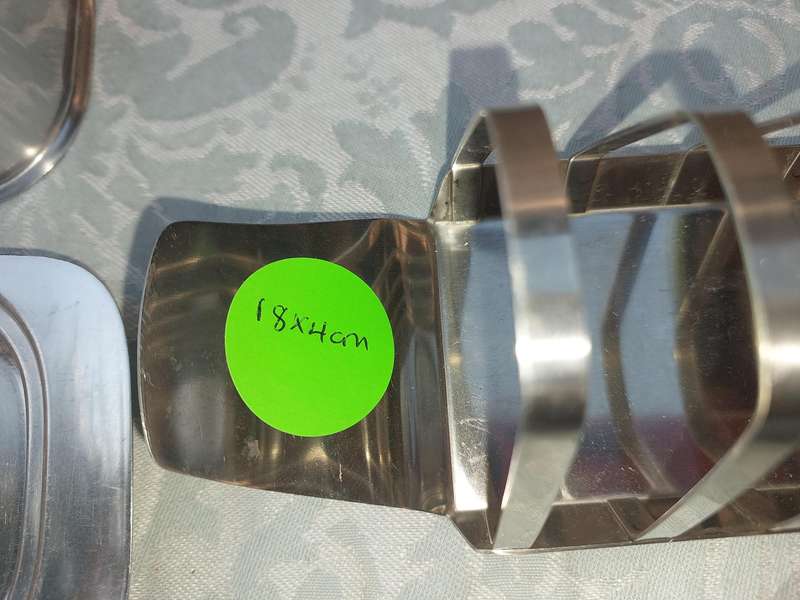 TWO STAINLESS STEEL UTENSILS A BUTTER DISH AND A TOAST STAND SOLD AS IS