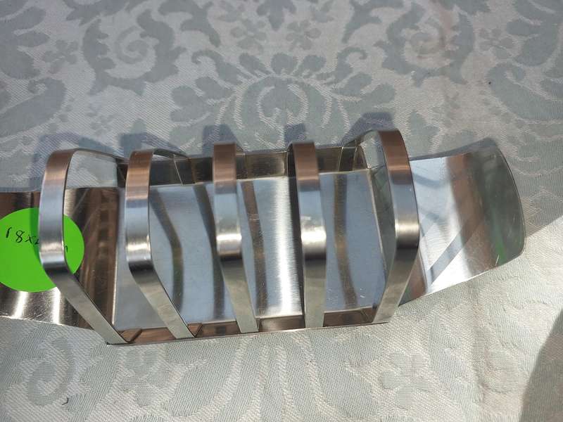 TWO STAINLESS STEEL UTENSILS A BUTTER DISH AND A TOAST STAND SOLD AS IS