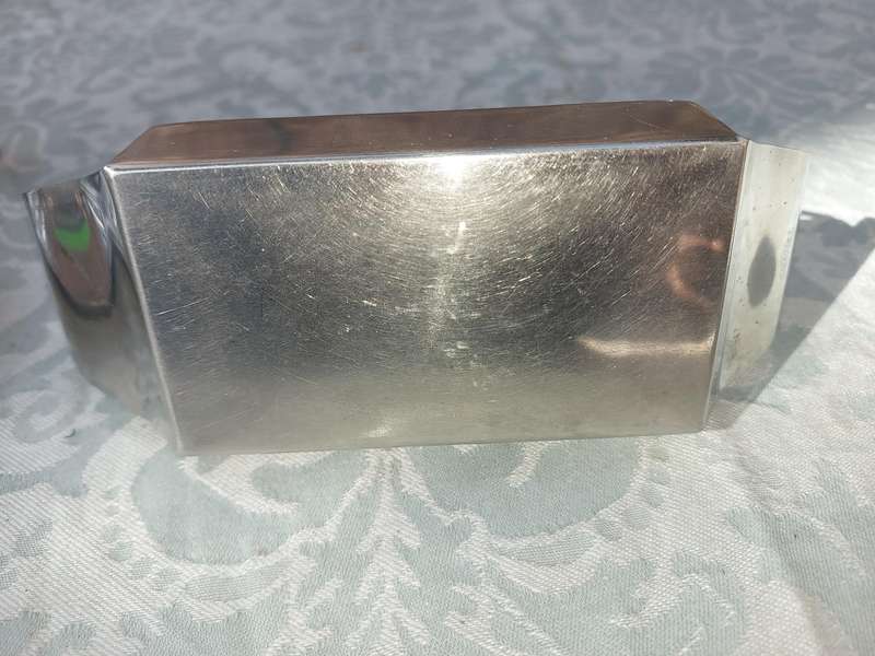 TWO STAINLESS STEEL UTENSILS A BUTTER DISH AND A TOAST STAND SOLD AS IS