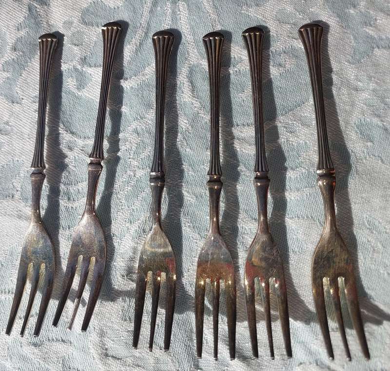 A VINTAGE SET OF DESERT FORKS SOLD AS IS