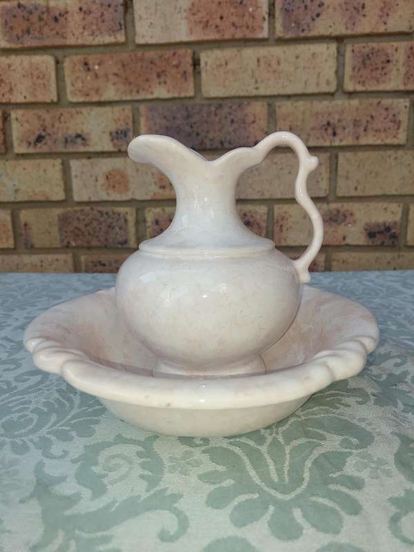 A PINK WATER PITCHER AND A BOWL PINK CERAMIC SOLD AS IS