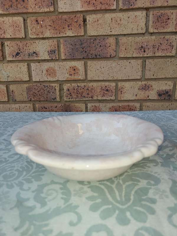 A PINK WATER PITCHER AND A BOWL PINK CERAMIC SOLD AS IS