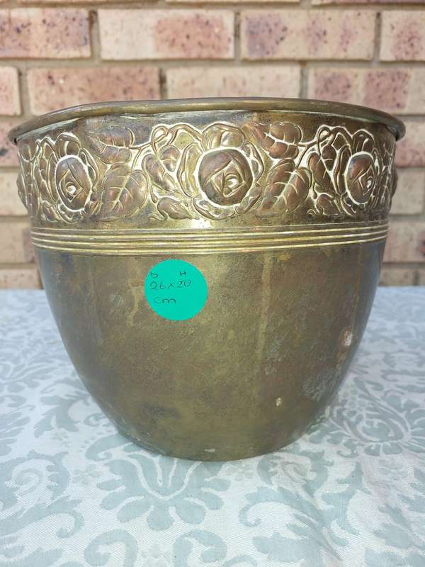 AN ORNATE BRASS PLANTER SOLD AS IS