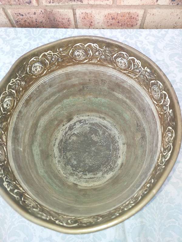 AN ORNATE BRASS PLANTER SOLD AS IS