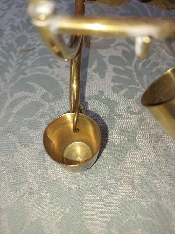 A VINTAGE HEBREW WINE DECANTER AND SIX CUPS BRASS ON A STAND ONE CUP NEED THE HANDLE TO BE ATTACHED