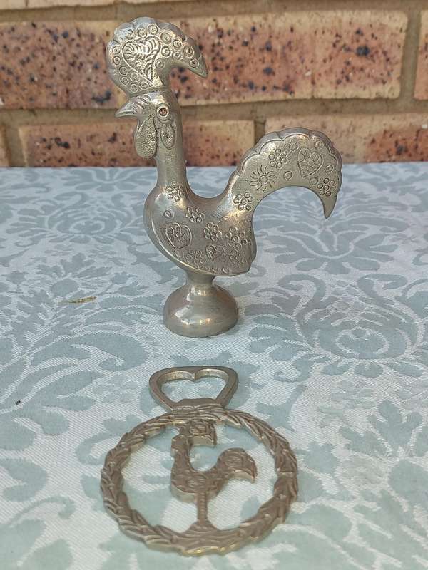 A COLLECTORS PORTUGESE SILVERPLATED ROOSTER AND A BOTTLE OPENER WITH THE ROOSTER SOLD AS IS