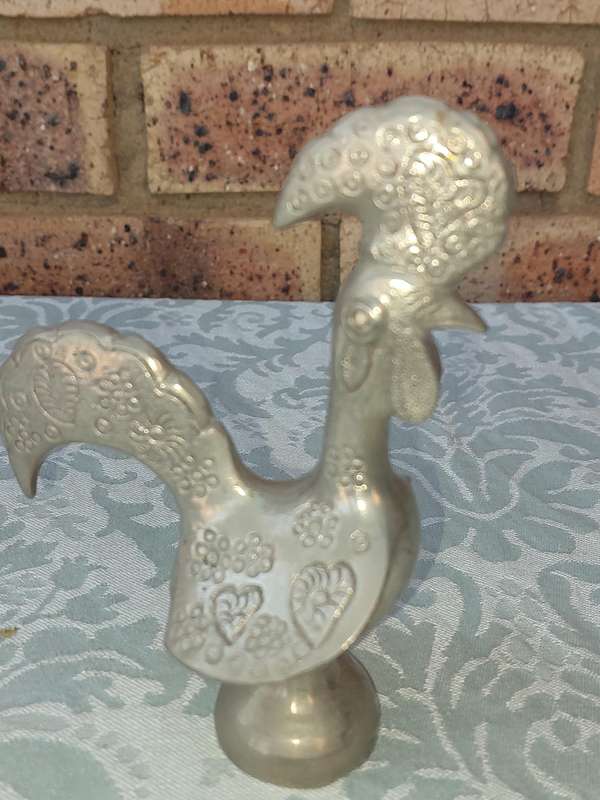 A COLLECTORS PORTUGESE SILVERPLATED ROOSTER AND A BOTTLE OPENER WITH THE ROOSTER SOLD AS IS