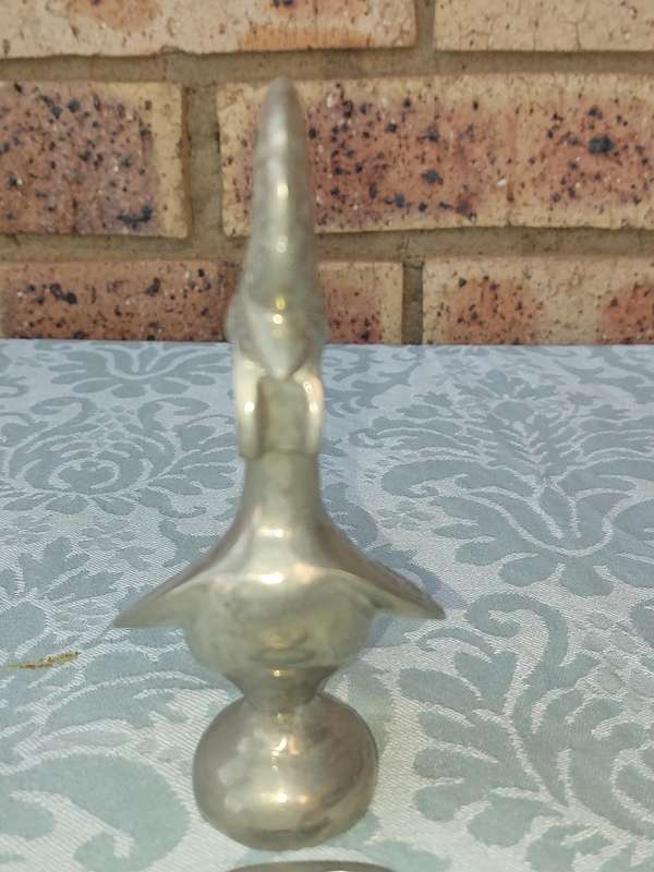 A COLLECTORS PORTUGESE SILVERPLATED ROOSTER AND A BOTTLE OPENER WITH THE ROOSTER SOLD AS IS