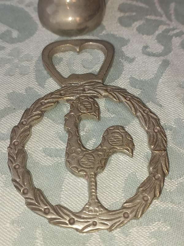 A COLLECTORS PORTUGESE SILVERPLATED ROOSTER AND A BOTTLE OPENER WITH THE ROOSTER SOLD AS IS