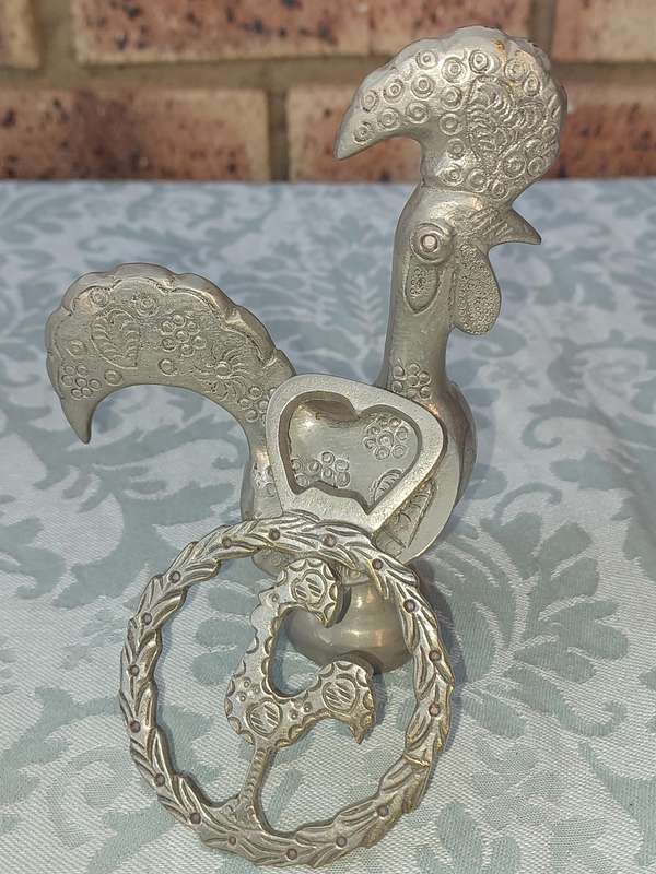 A COLLECTORS PORTUGESE SILVERPLATED ROOSTER AND A BOTTLE OPENER WITH THE ROOSTER SOLD AS IS
