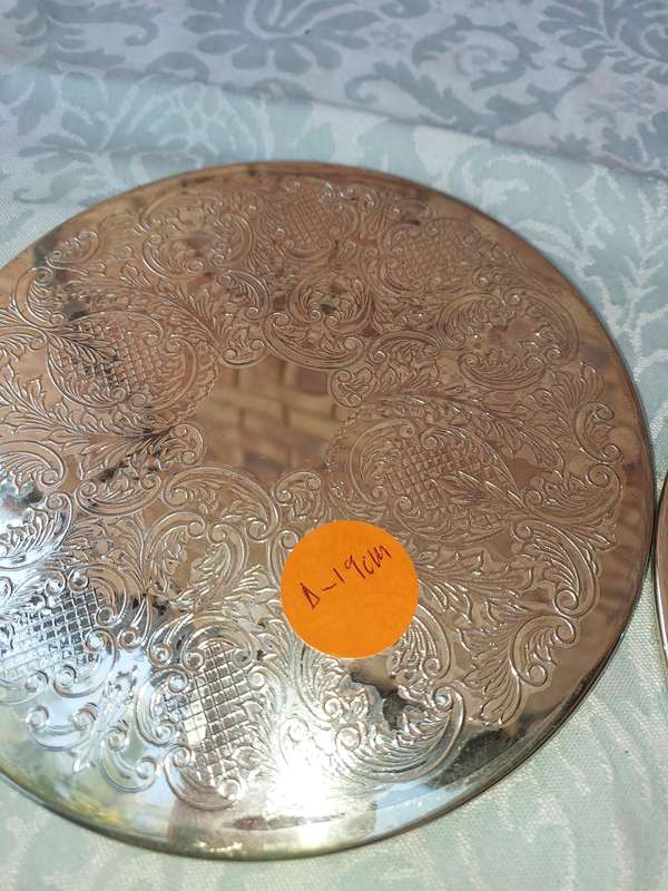 A PAIR OF ORNATE SILVER PLATED HOTPOT PLACE MATS