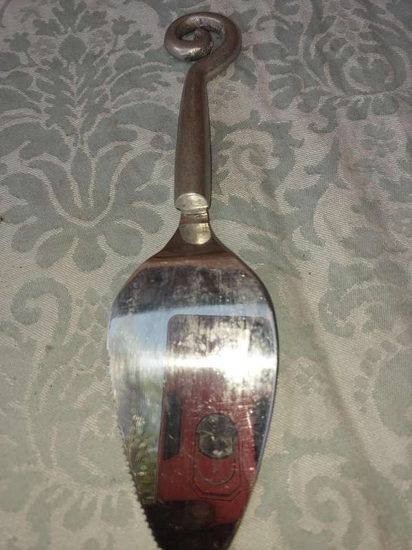 A PAIR OF PEWTEL CARROL BOYES STYLE CAKE CUTTERS SOLD AS IS