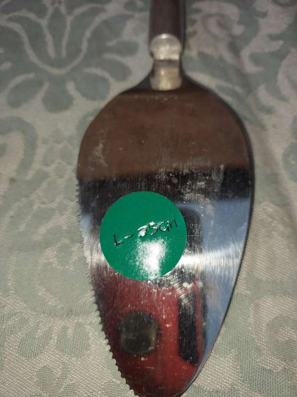 A PAIR OF PEWTEL CARROL BOYES STYLE CAKE CUTTERS SOLD AS IS