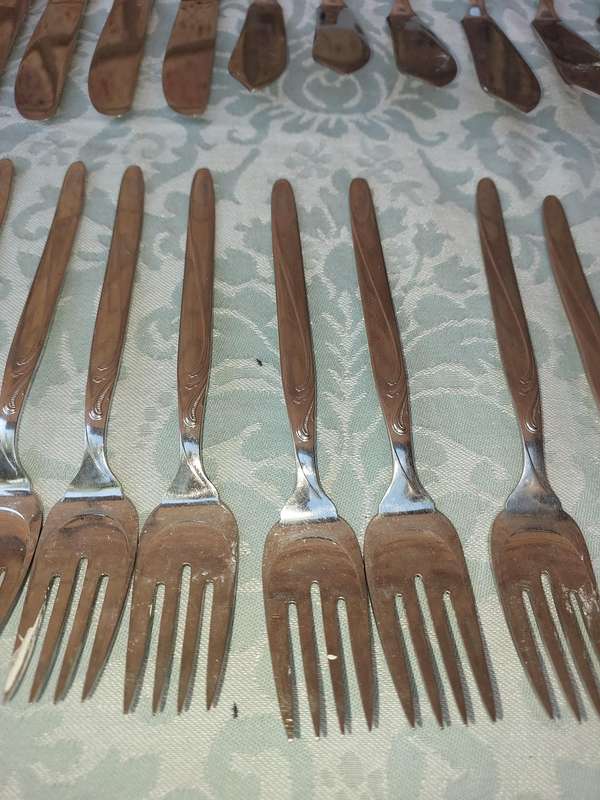 A SET OF VINTAGE GERMAN STAINLESS STEEL CUTLERY SOLD AS IS