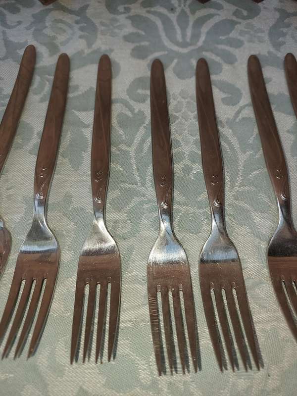 A SET OF VINTAGE GERMAN STAINLESS STEEL CUTLERY SOLD AS IS
