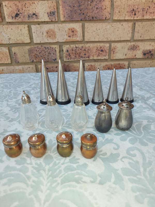 A COLLECTIONOF SALT AND PEPPER DISPENSORS SOLD AS IS