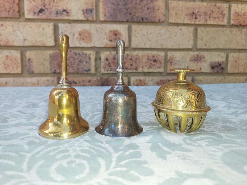 A COLLECTION OF BELLS SOLD AS IS