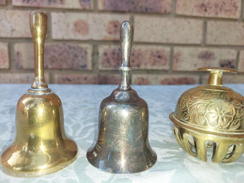 A COLLECTION OF BELLS SOLD AS IS