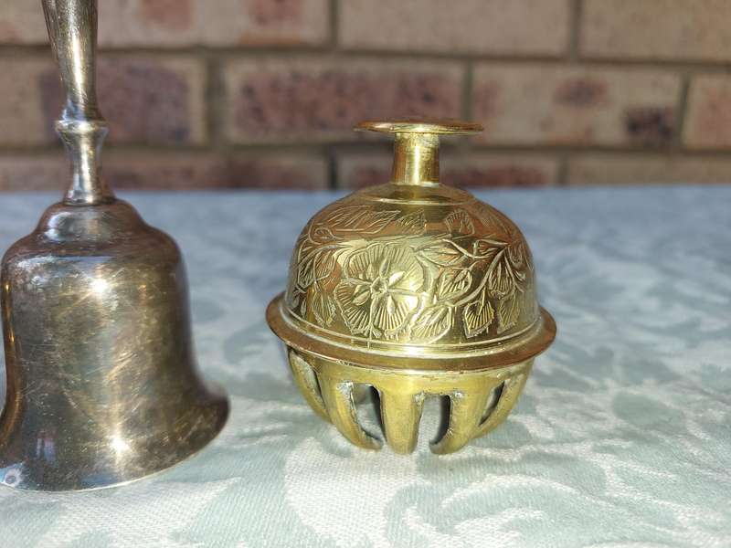 A COLLECTION OF BELLS SOLD AS IS