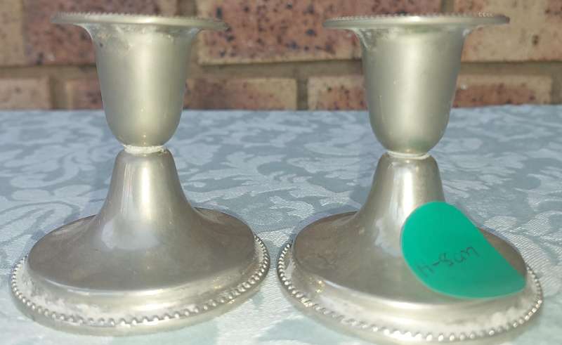 A PAIR OF SILVER PLATED CANDLE STANDS SOLD AS IS