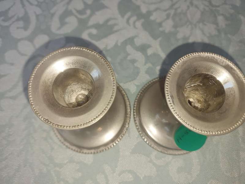 A PAIR OF SILVER PLATED CANDLE STANDS SOLD AS IS