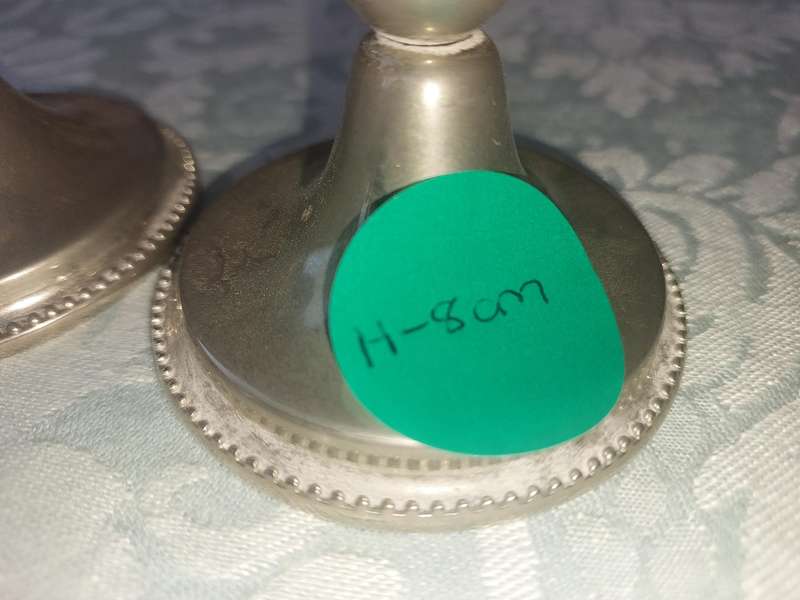 A PAIR OF SILVER PLATED CANDLE STANDS SOLD AS IS