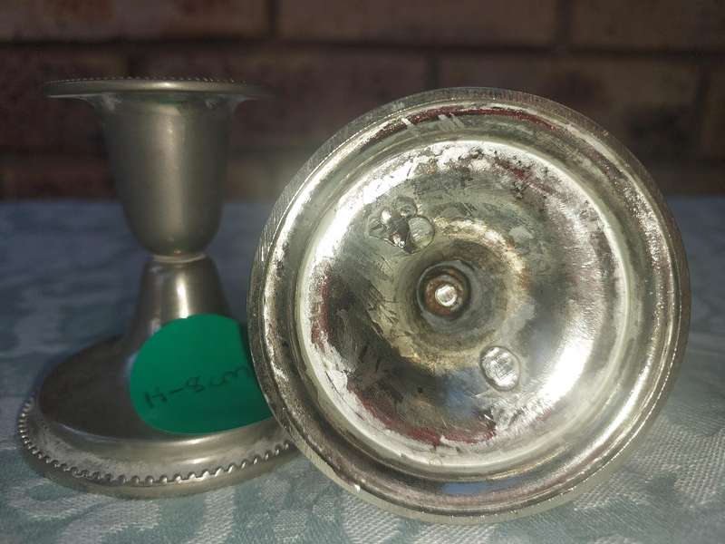 A PAIR OF SILVER PLATED CANDLE STANDS SOLD AS IS