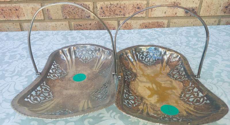 A PAIR OF SILVERPLATED TEMPLE DECOR HANDLED SERVING BASKETS SOLD AS IS