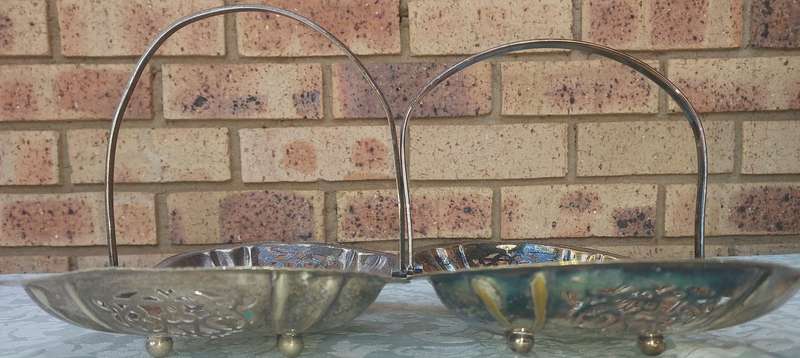 A PAIR OF SILVERPLATED TEMPLE DECOR HANDLED SERVING BASKETS SOLD AS IS