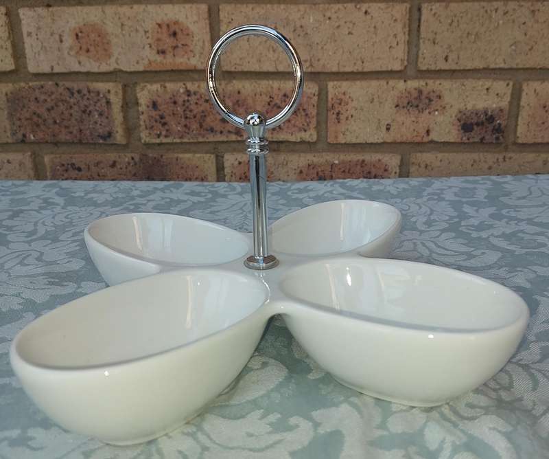 A PORCELAIN FOUR COMPARTMENT SWEET STAND SOLD AS IS