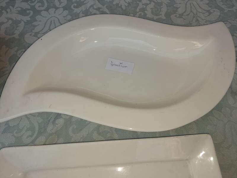 A COLLECTION OF BASIC WHITE PORCELAIN SERVING PLATTERS SOLD AS IS