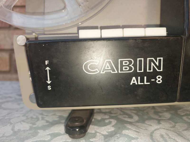AN ANTIQUE MOVIE PROJECTOR WIYHOUT THE POWER CABLE SOLD AS IS NOT TESTED