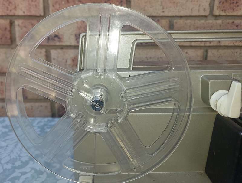 AN ANTIQUE MOVIE PROJECTOR WIYHOUT THE POWER CABLE SOLD AS IS NOT TESTED