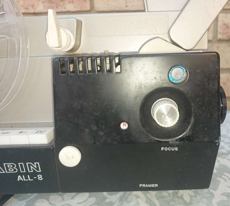 AN ANTIQUE MOVIE PROJECTOR WIYHOUT THE POWER CABLE SOLD AS IS NOT TESTED