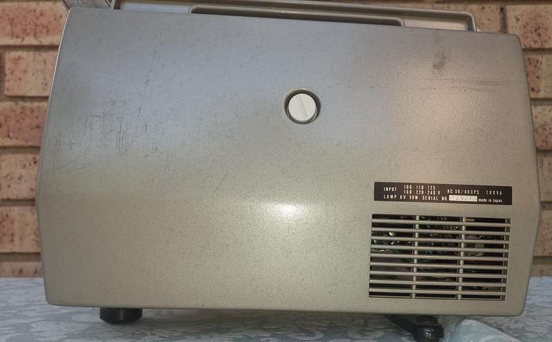 AN ANTIQUE MOVIE PROJECTOR WIYHOUT THE POWER CABLE SOLD AS IS NOT TESTED