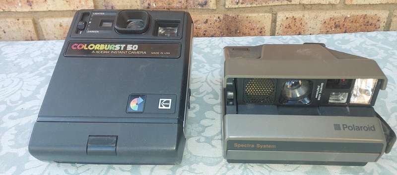A TWO POLAROID CAMERAS SOLD AS IS