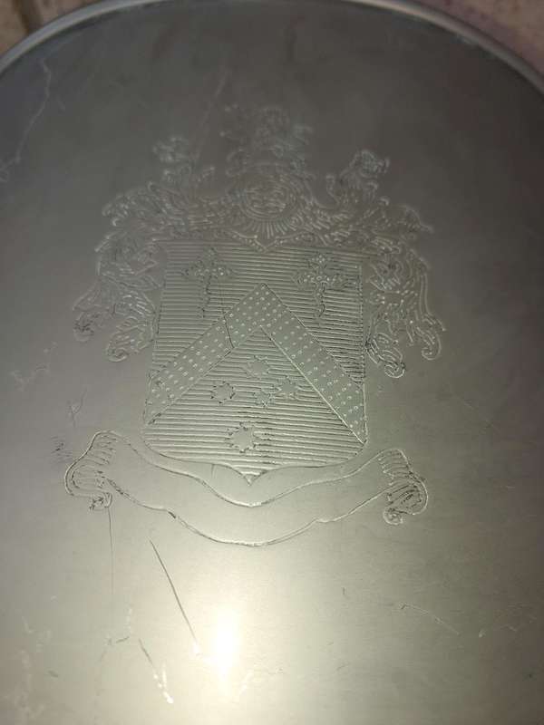 AN EXCLUSIVE CHAMPAIGNE ICE BUCKET WITH A COAT OF ARMS ENGRAVED SOLD AS IS
