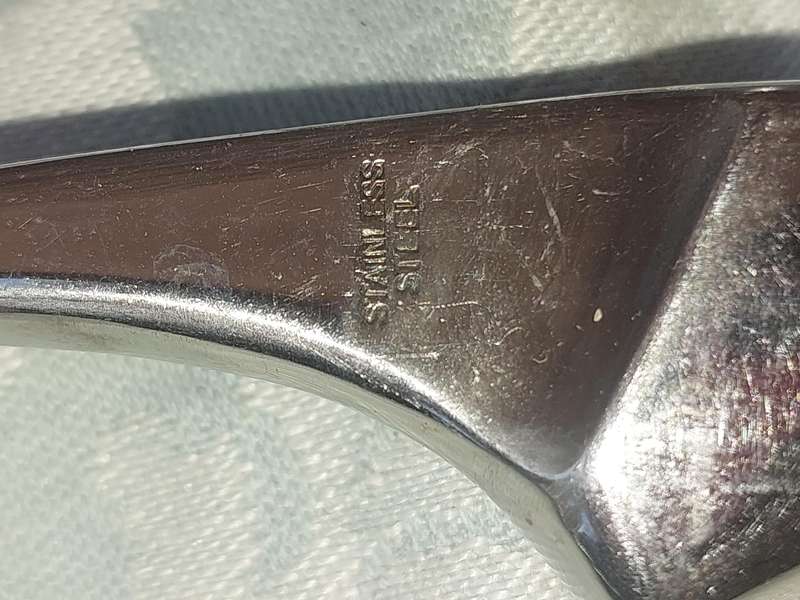A VINTAGE STAINLESS STEEL CARVING SET SOLD AS IS