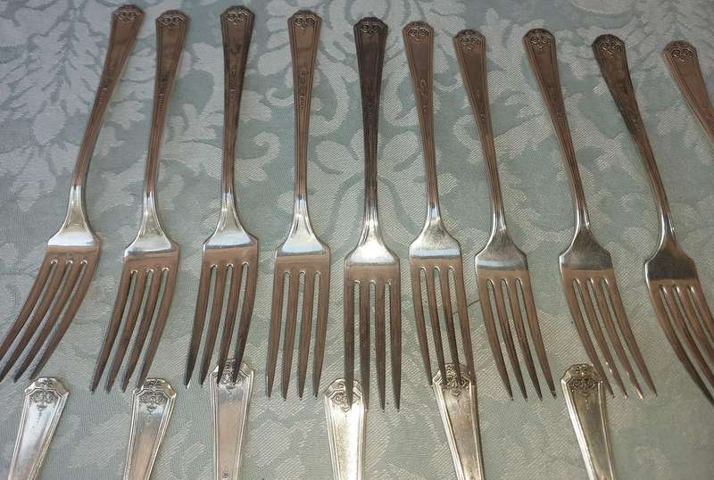 A VINTAGE SET OF STAINLESS STEEL CUTLERY SOLD AS IS