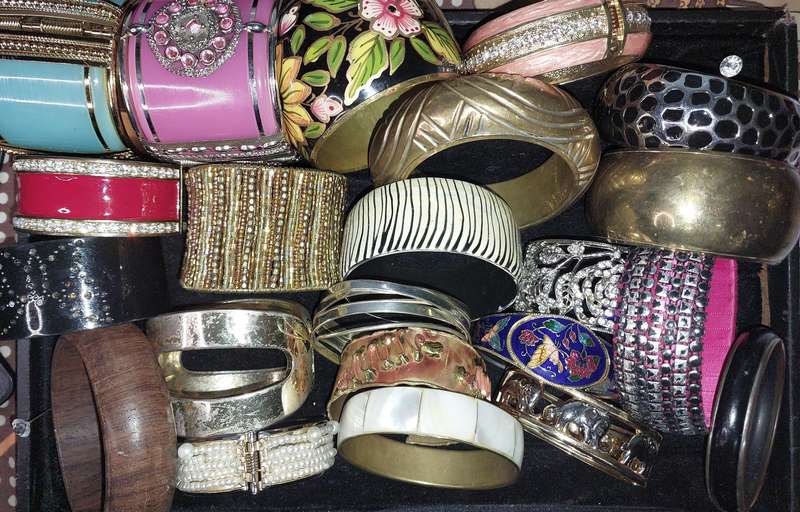 A VINTAGE COLLECTION OF BRACELETS SOLD AS IS