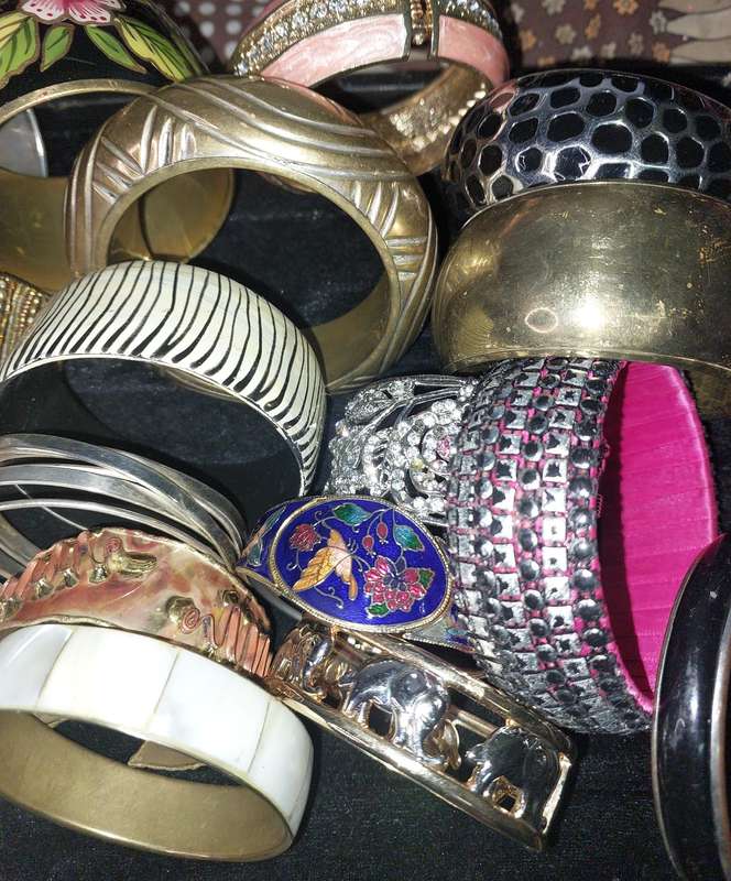 A VINTAGE COLLECTION OF BRACELETS SOLD AS IS
