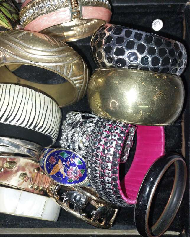 A VINTAGE COLLECTION OF BRACELETS SOLD AS IS