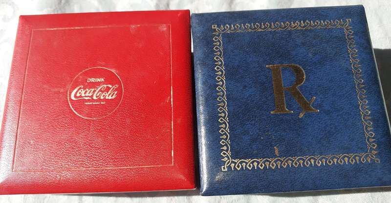 A RARE SET OF COASTERS COCA COOA AND A BLUE SET