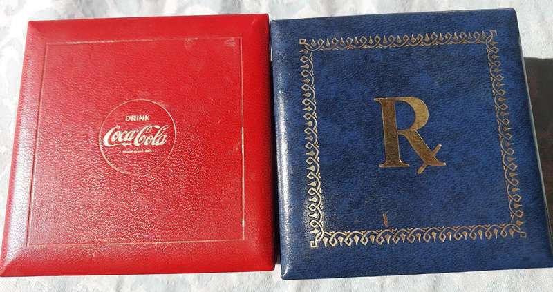 A RARE SET OF COASTERS COCA COOA AND A BLUE SET