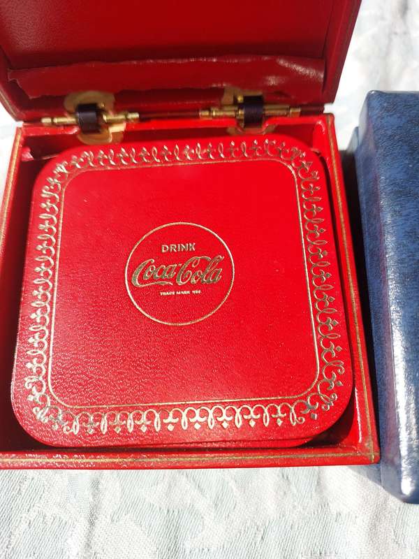 A RARE SET OF COASTERS COCA COOA AND A BLUE SET