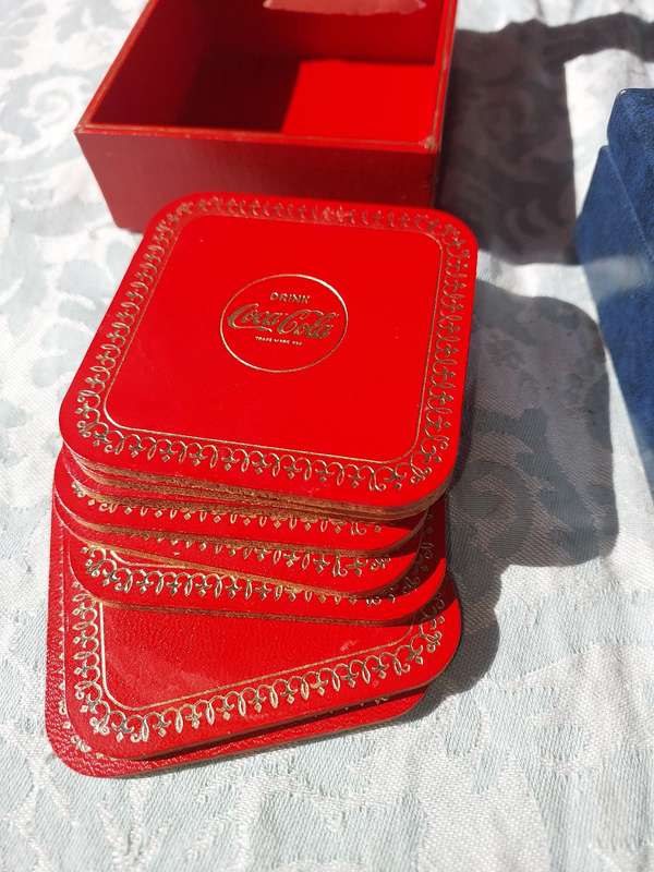 A RARE SET OF COASTERS COCA COOA AND A BLUE SET