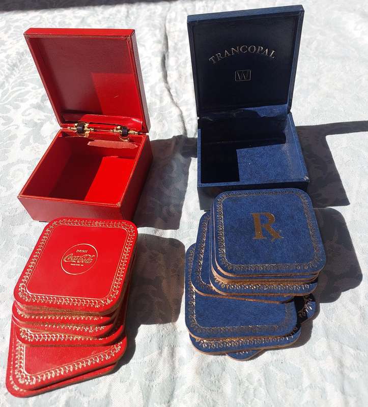 A RARE SET OF COASTERS COCA COOA AND A BLUE SET