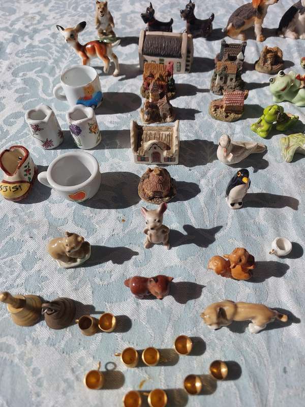 AN ENTIRE COLLECTION PORCELAIN CHARMS AND FIGURINES SOLD AS IS
